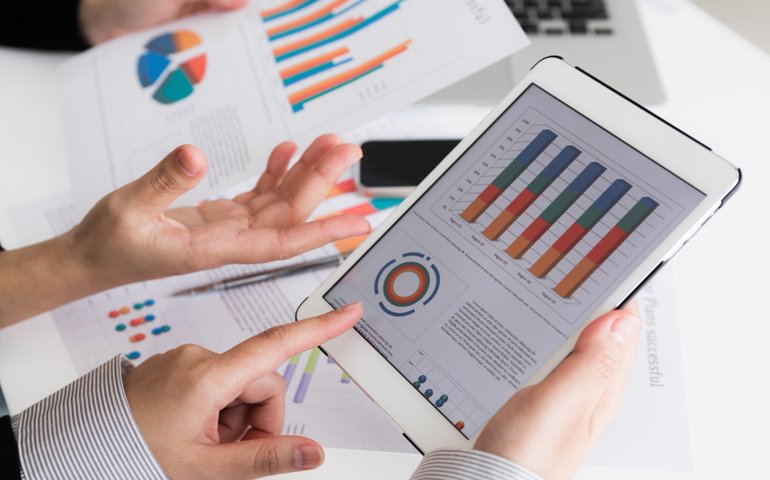 close up business team using digital tablet with financial