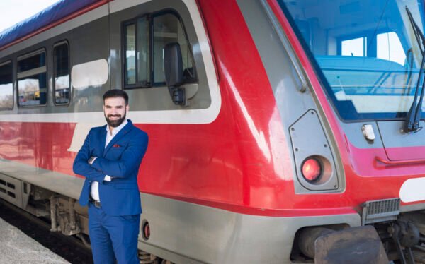 portrait professional train driver standing by high speed train vehicle station